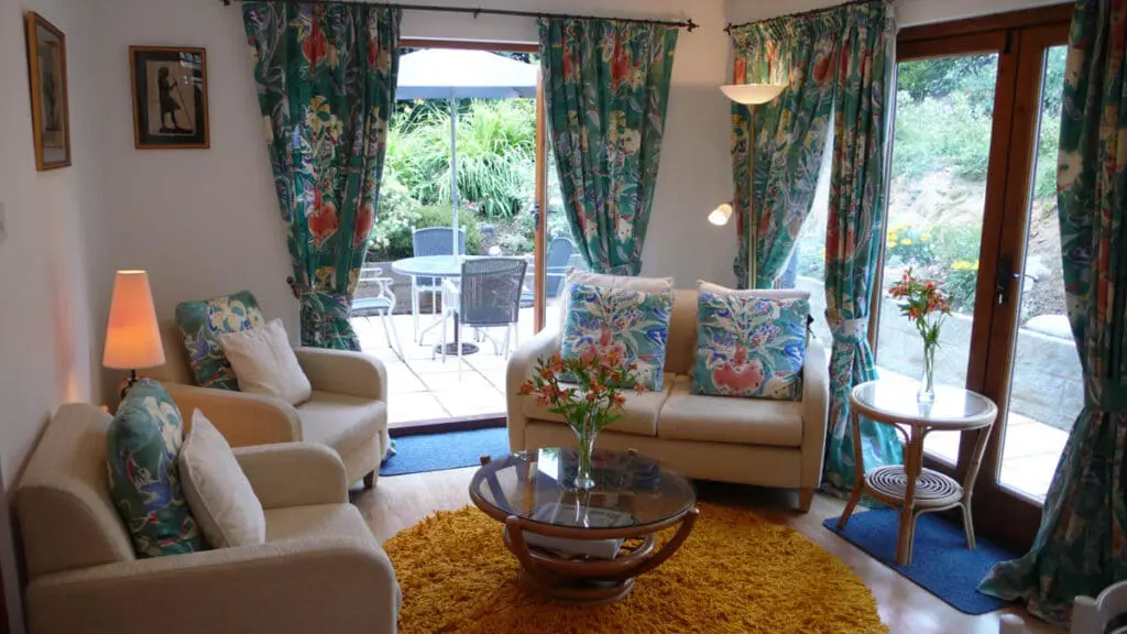 La Cachette bright living room with doors to the patio