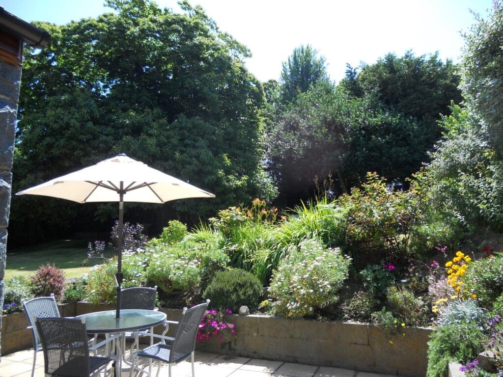Garden patio with parasol and dining set