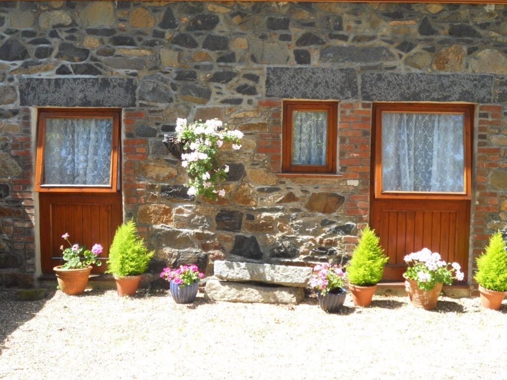 Granite cottage doors with flowering pots