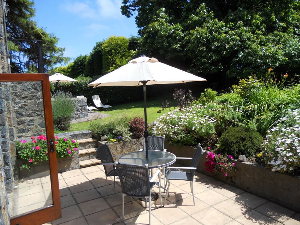 Private patio with parasol and dining set